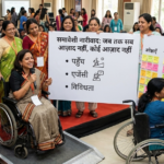 Image of a wheelchair user in workshop with participants around her